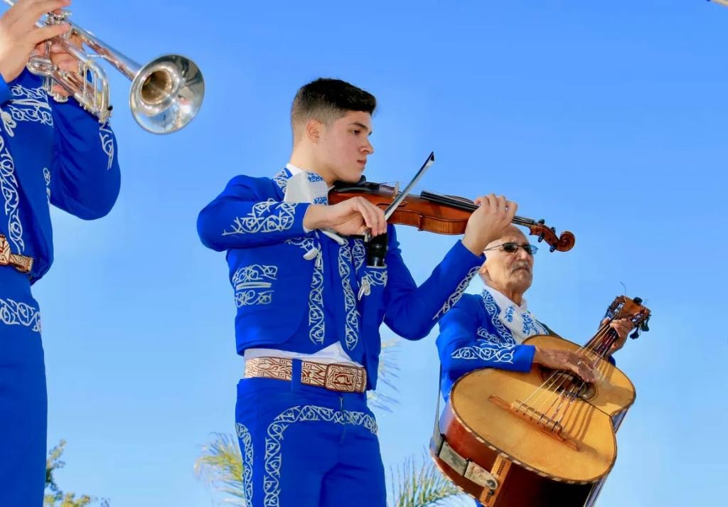 Mariachi musicians in blue suits close up with violin and guitar
